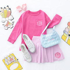 Light pink girls twirl skort flatlay with crewneck sweatshirt