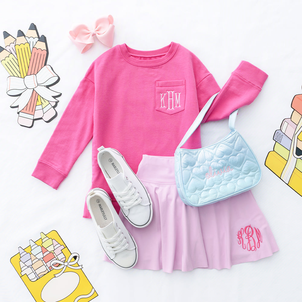 Light pink girls twirl skort flatlay with crewneck sweatshirt