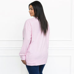 light pink monogrammed sequin wreath sweatshirt on julia from behind