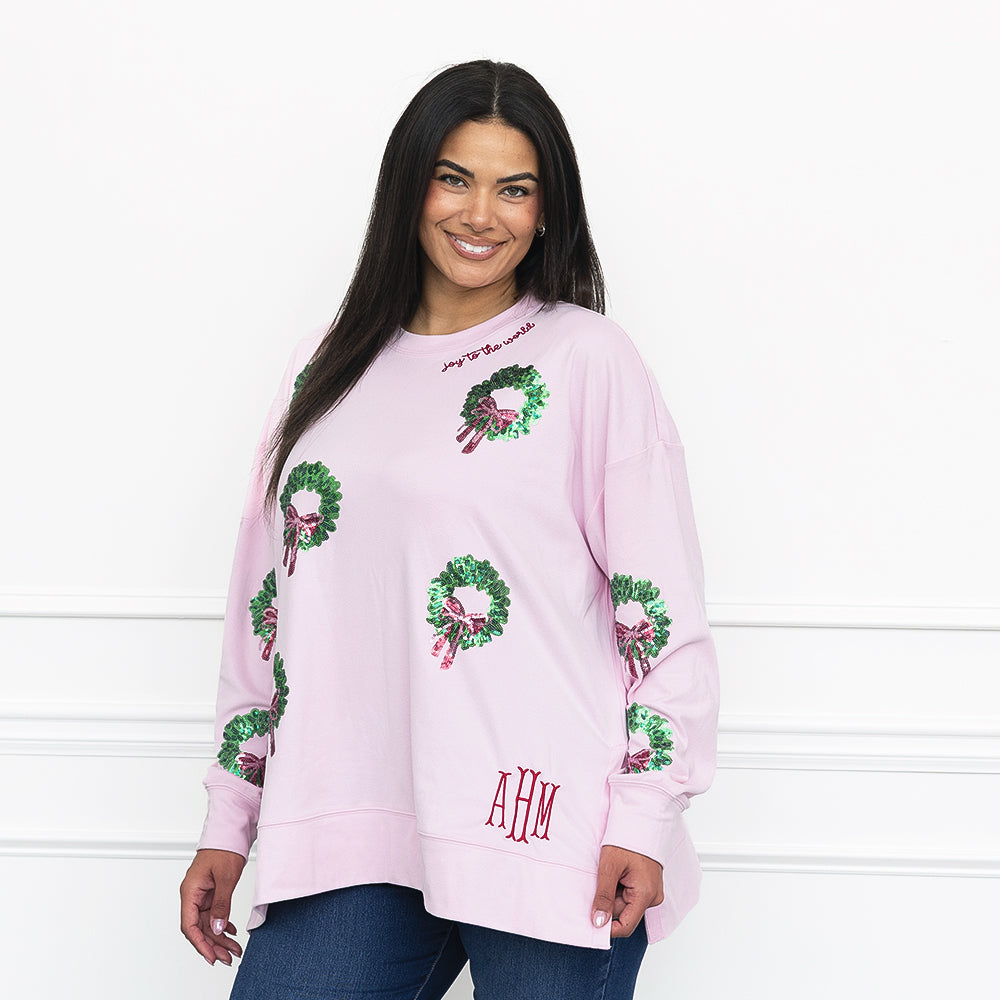 light pink monogrammed sequin wreath sweatshirt on julia