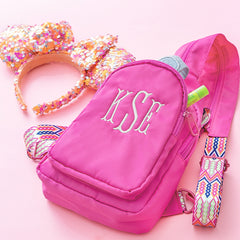 hot pink personalized sling backpack with theme park accessories
