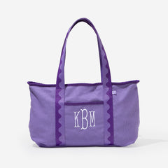 Purple tote bag with 'KBM' monogram on a white background