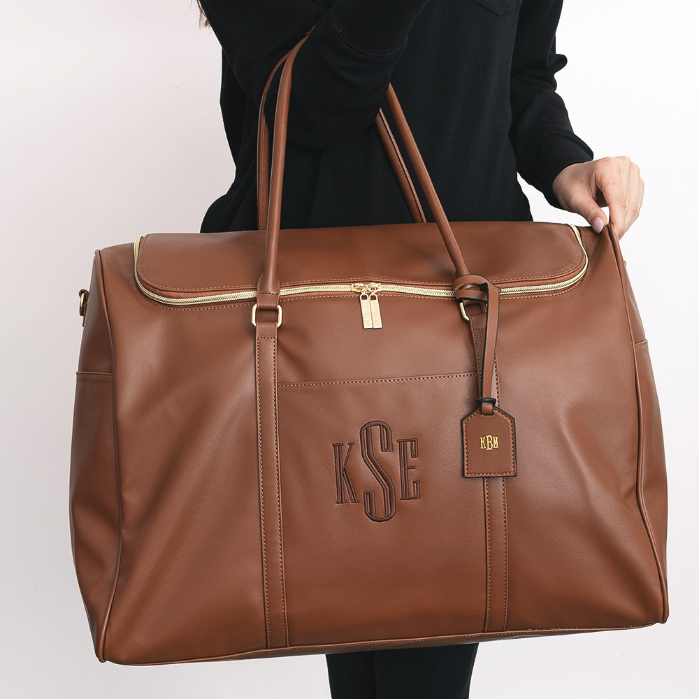 monogrammed bag tag in dark brown on weekend travel bag
