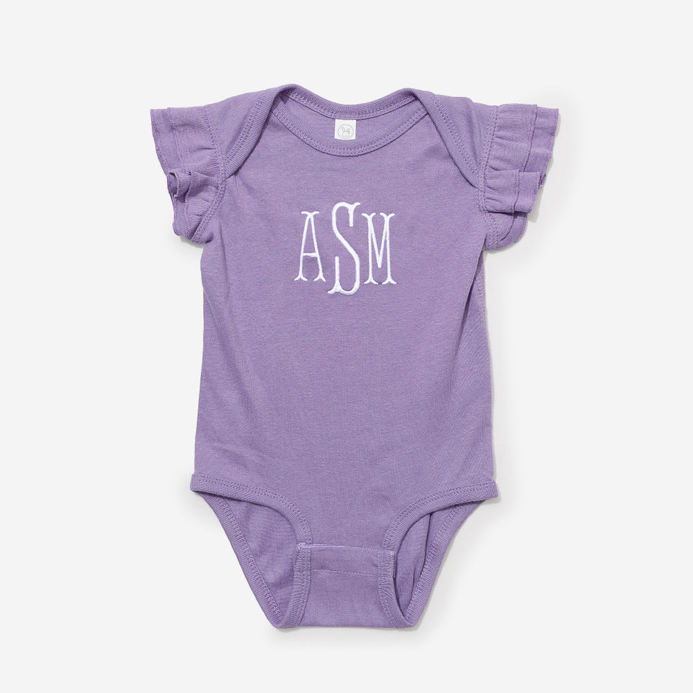 Purple baby onesie with ruffled sleeves and 'ASM' monogram on a white background