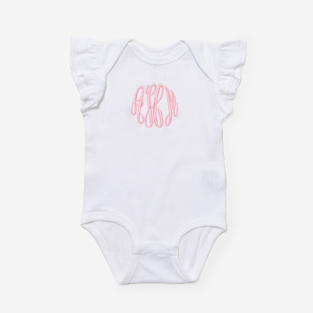 White baby onesie with pink monogram on a white background