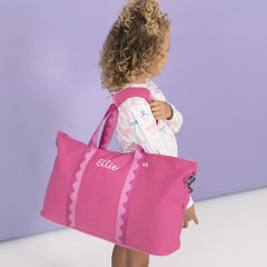 monogrammed kids weekend bag in pink punch over shoulder 