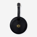 Black leather luggage tag with gold monogram on a white background