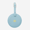 Mint leather luggage tag with gold monogram on a white background