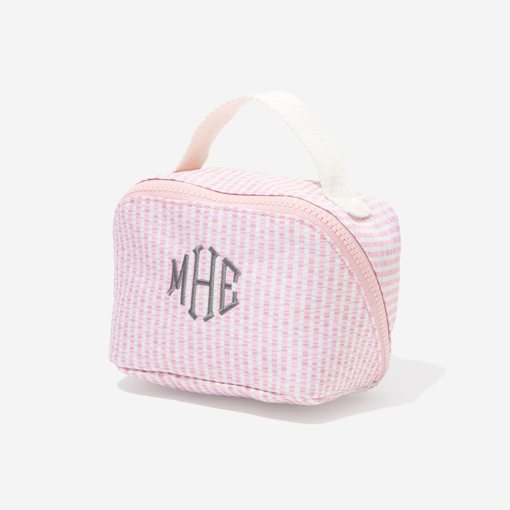 Pink seersucker toiletry bag with 'MHE' monogram on a white background