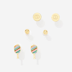 Engraved gold earrings, gold ball earrings, and colorful striped pickleball paddle earrings on a white background