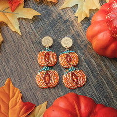 monogrammed pumpkin earrings on wood 