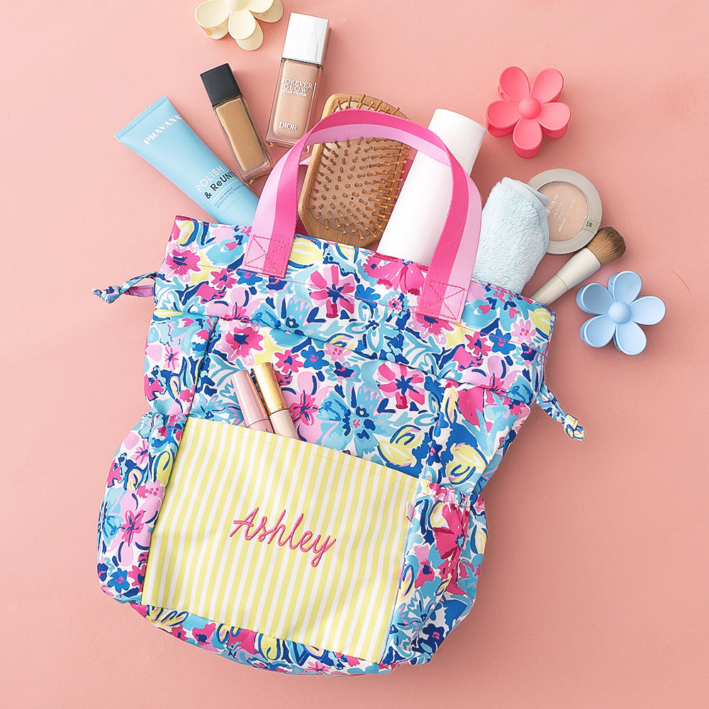 monogrammed toiletry bag with floral design, drawstring closure, and handles