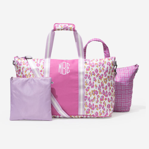 Set of pink and cheetah print bags with a monogram on a white background