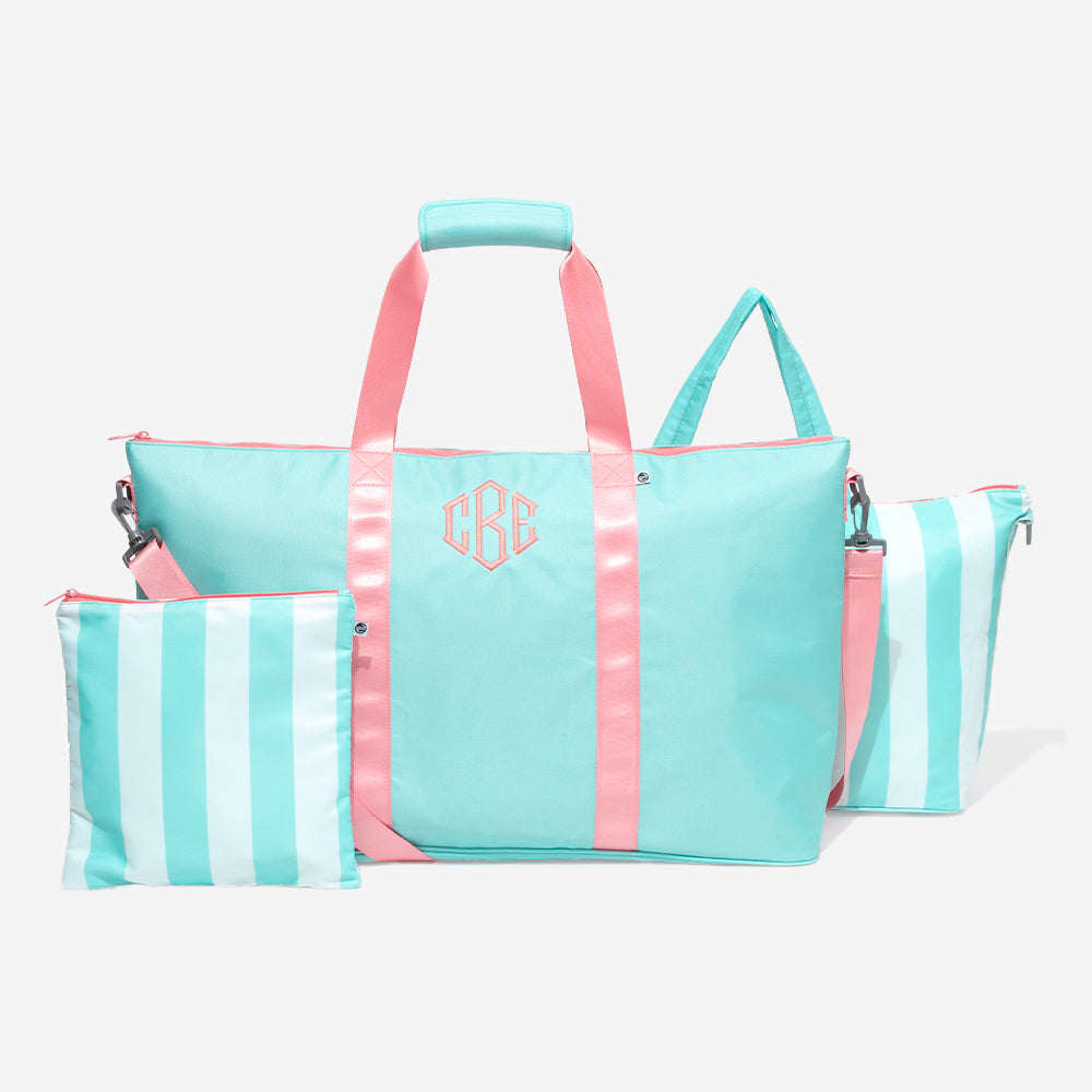 Mint tote bag with pink straps and a matching pouch on a white background