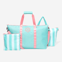 Mint tote bag with pink straps and a matching pouch on a white background