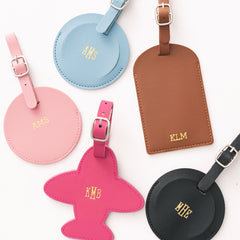 Set of colorful luggage tags with monograms on a white background
