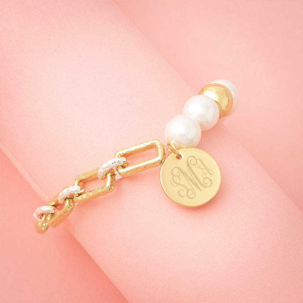 gold pearl bracelet on pink background