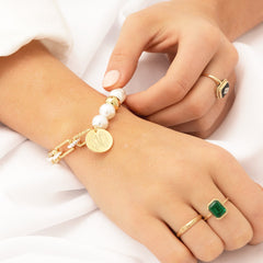 gold pearl bracelet on wrist
