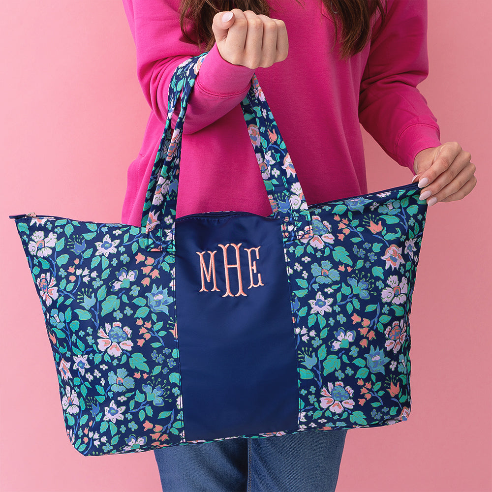 navy floral trellis packable weekend duffel bag held by girl