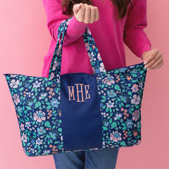 navy floral trellis packable weekend duffel bag held by girl