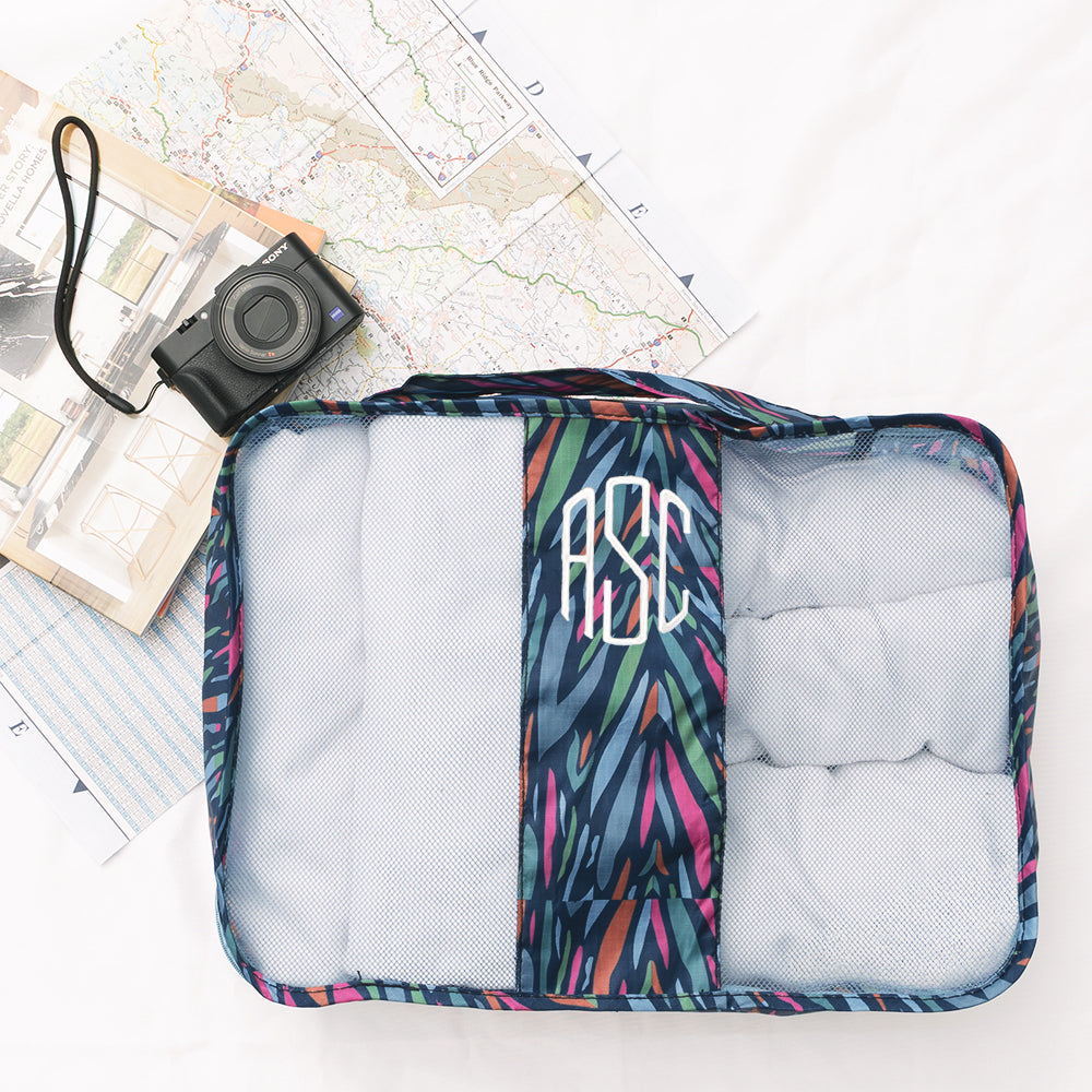 navy safari packing bag with map and camera