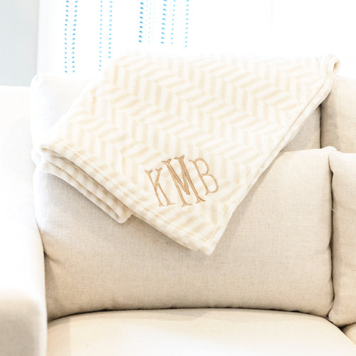 neutral herringbone plush blanket on couch