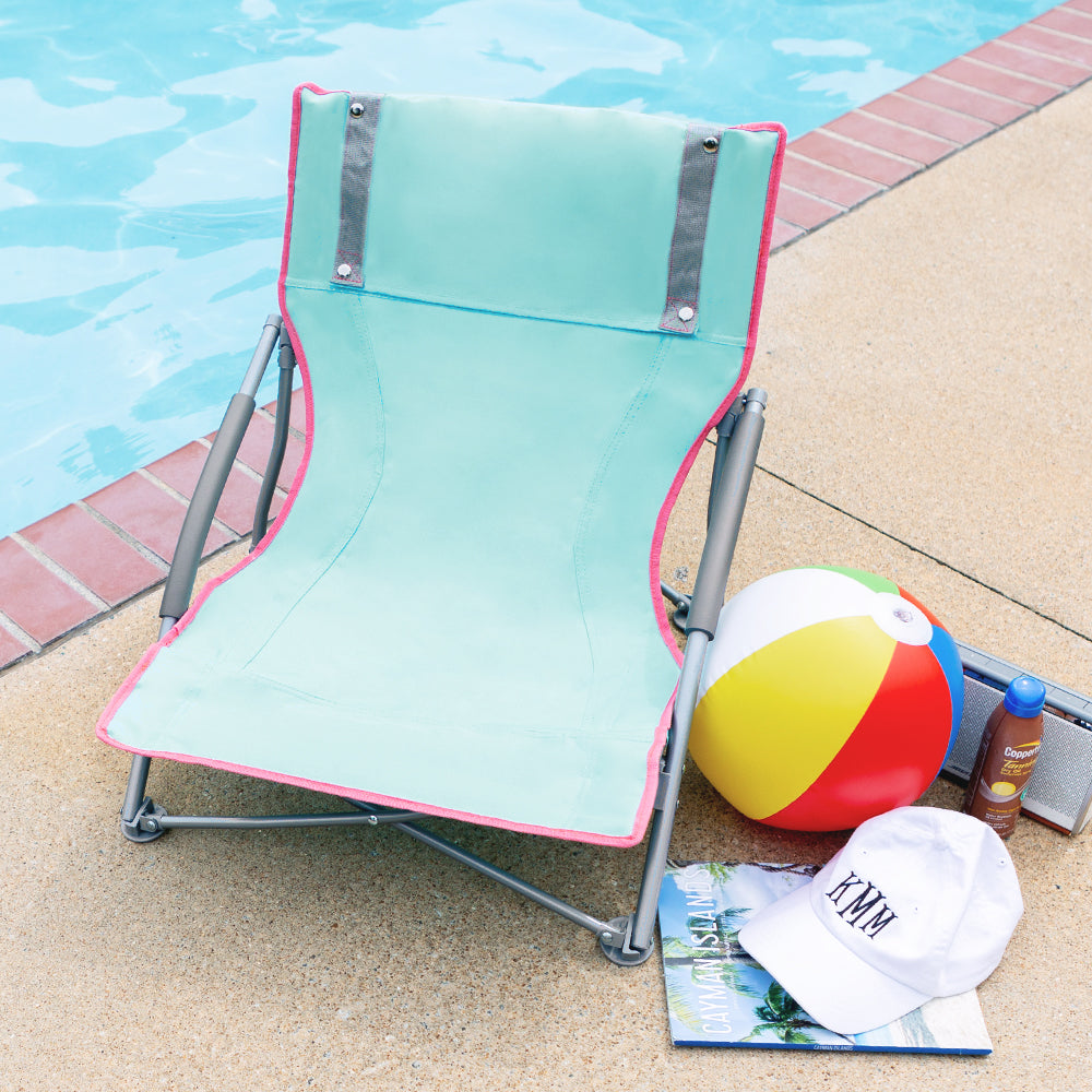 front of monogrammed beach chair at the pool