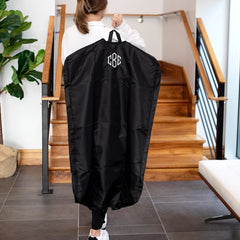carrying packable garment bag on shoulder