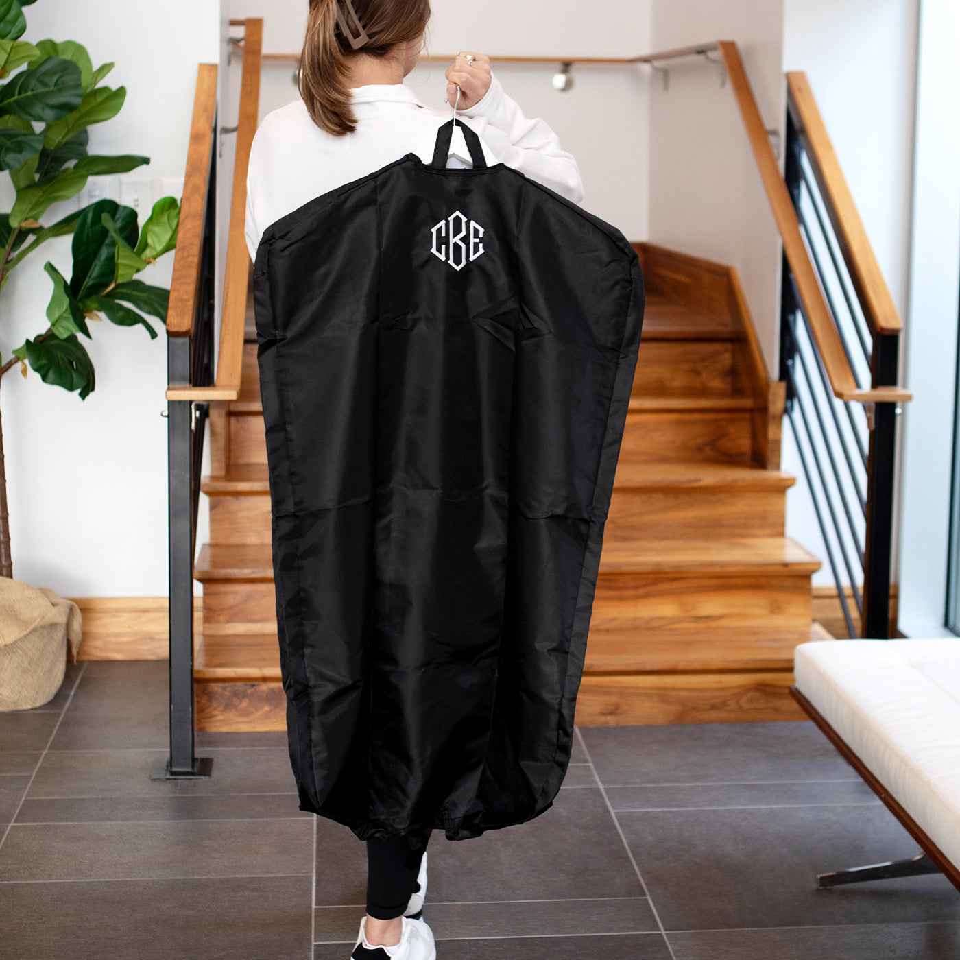 carrying packable garment bag on shoulder