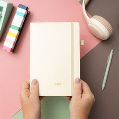 light tan notebook in hands