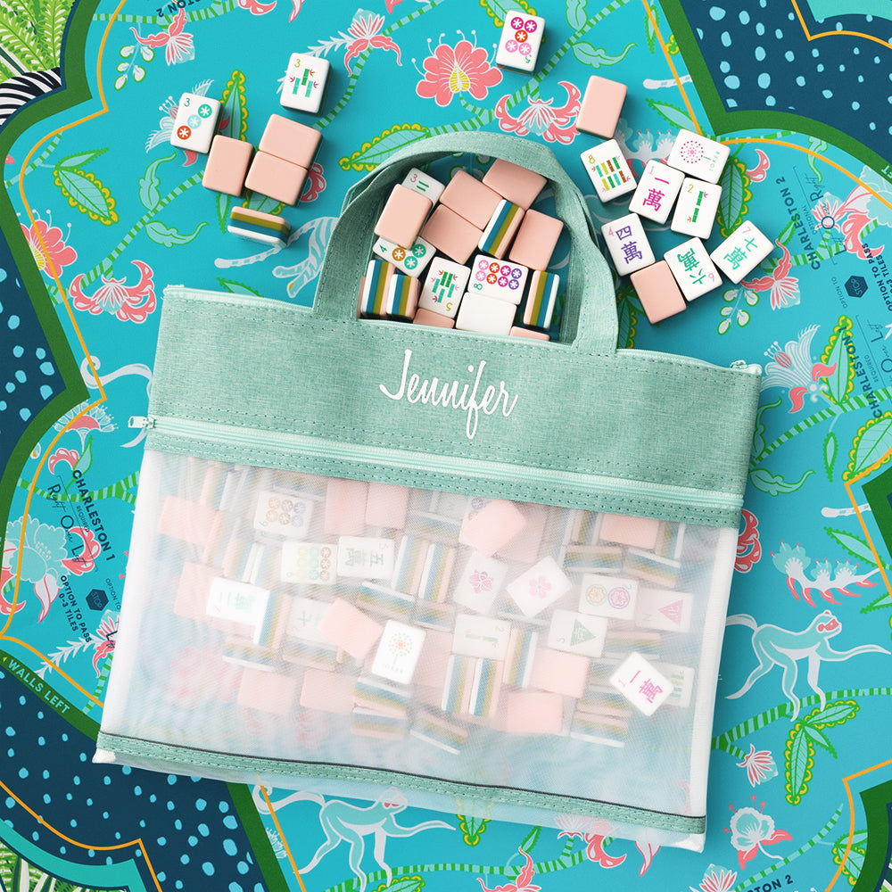 mint and hot pink monogrammed reusable storage bags on mahjong board