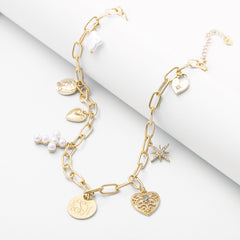 pearl signature charm necklace on white roll