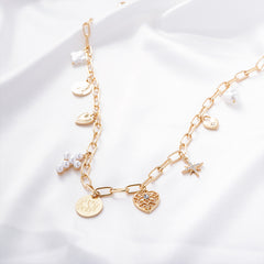 pearl signature charm necklace on white satin