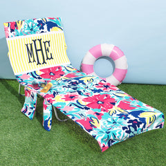 monogrammed pool chair cover with floral design and yellow and white stripes block at top.