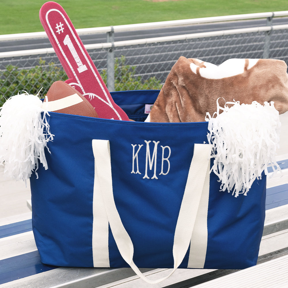 personalized extra large tote bag in blue on stadium seats 