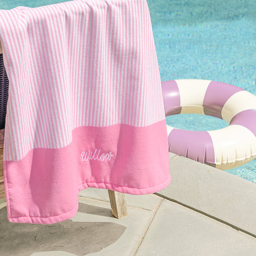 kids pink striped beach towel at the pool