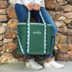 pine cooler held in front of brick wall