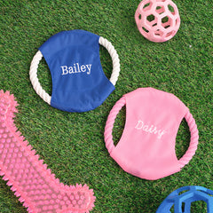 pink and blue personalized frisbees with dog toys