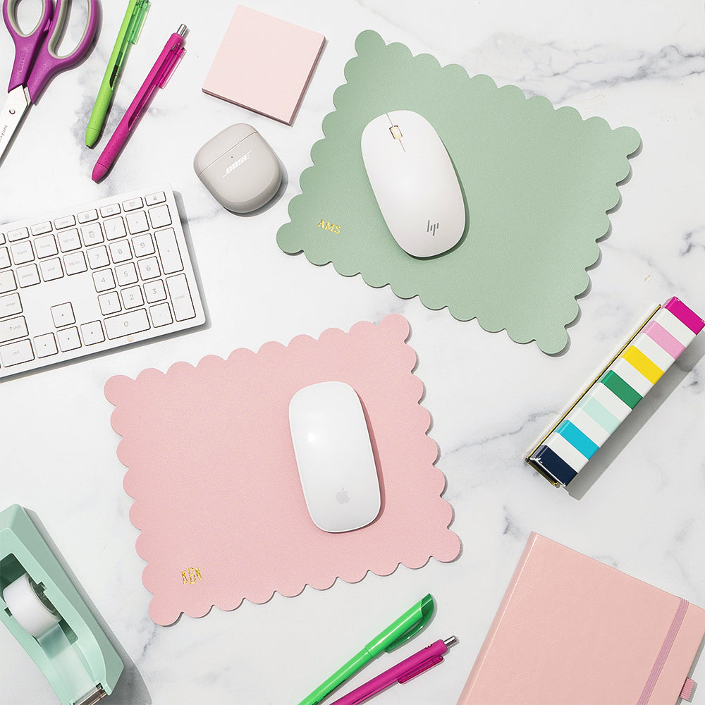 computer desk with monogrammed mouse pads, keyboard, and office items