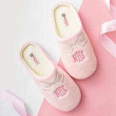 pink bows slippers on pink and white paper
