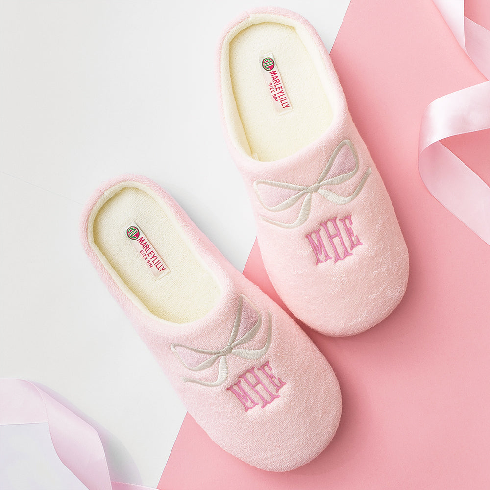 pink bows slippers on pink and white paper