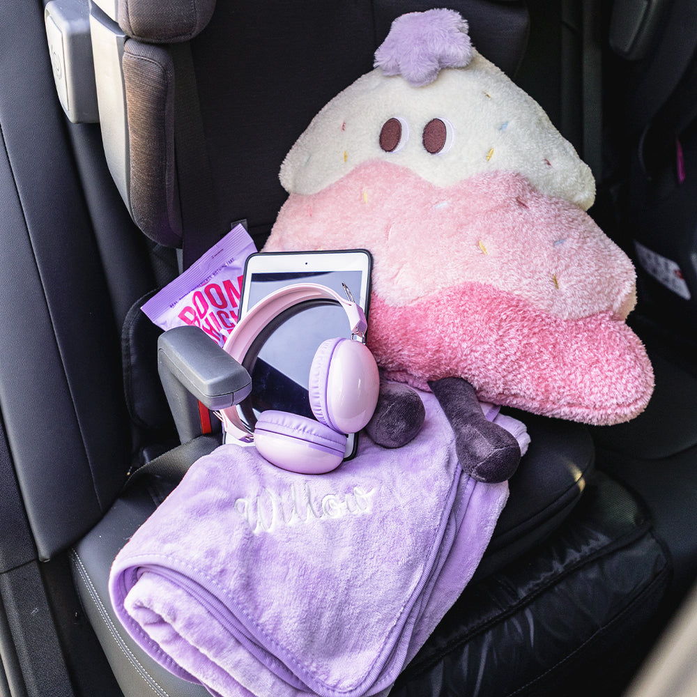 pink kids blanket pillow in car