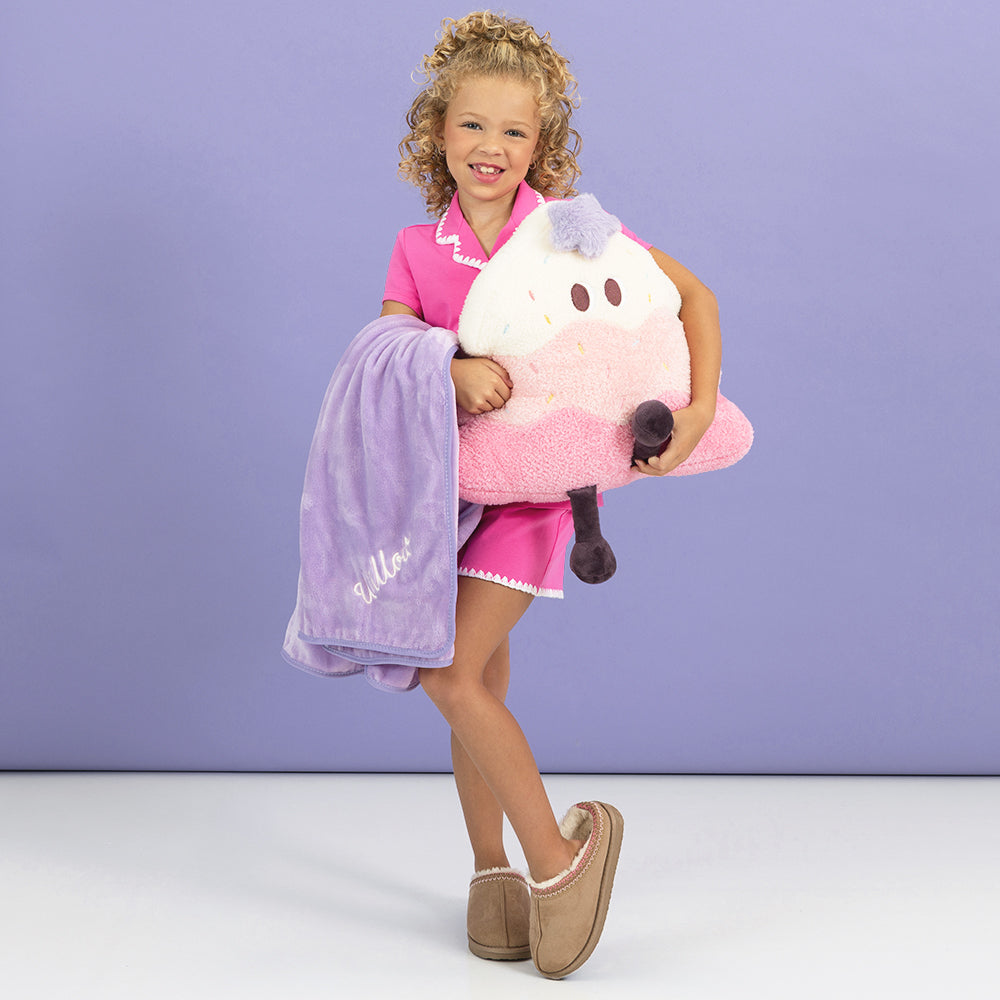 pink kids blanket pillow in hands