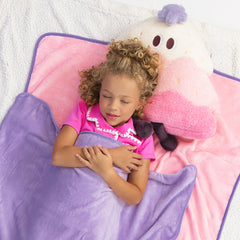 pink kids blanket pillow with jaxy laying down