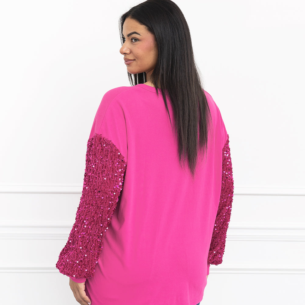 pink nutcracker sweatshirt on julia from behind