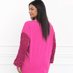 pink nutcracker sweatshirt on julia from behind
