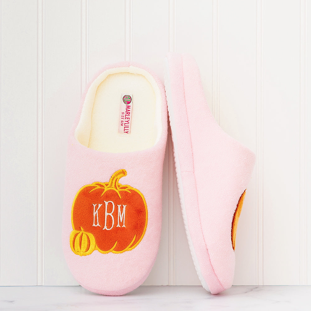 pink pumpkins slippers against wall