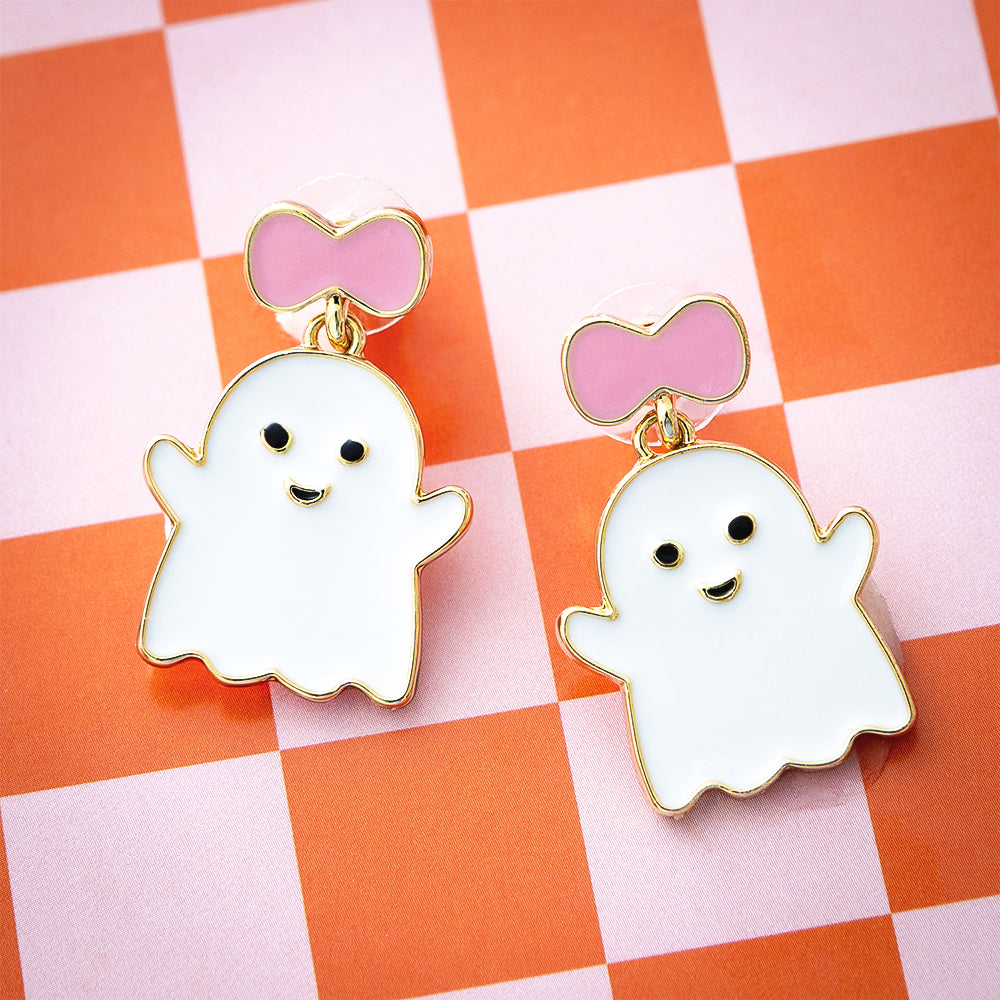 pink white ghost earrings on orange checkerboard