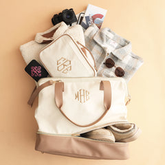 ivory travel toiletry bag with canvas weekender flatlay