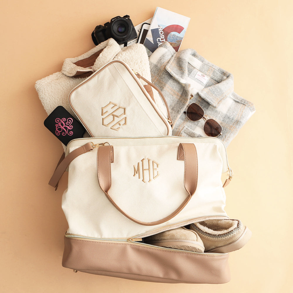 ivory travel toiletry bag with canvas weekender flatlay